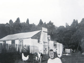 Noel's sister Phyllis outside my grandparents home in Waimiha-1922